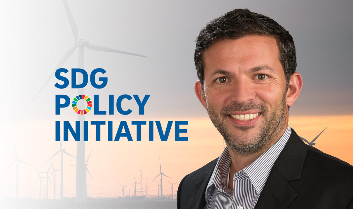 Gordon McCord with the SDG Policy Initiative logo against a background of wind turbines